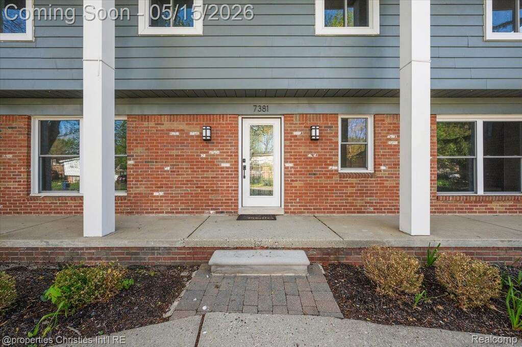 Entrance to property with brick siding
