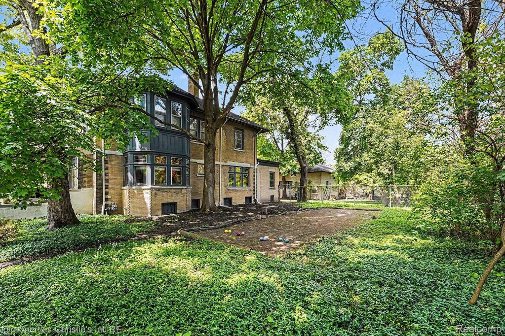 Rear view of property with brick siding