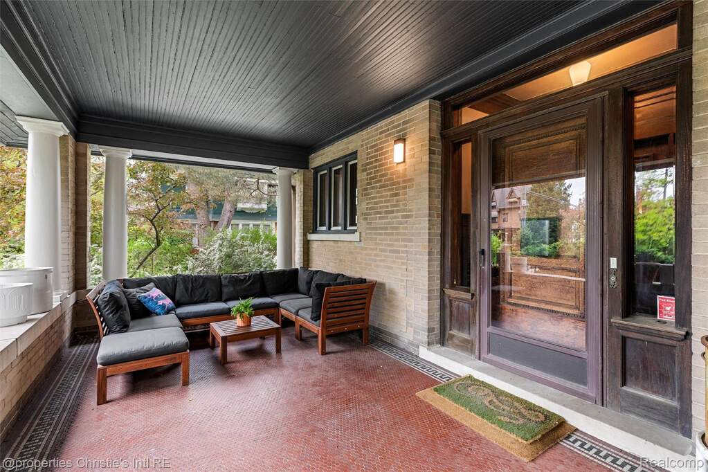 Sunroom / solarium featuring healthy amount of natural light and brick wall