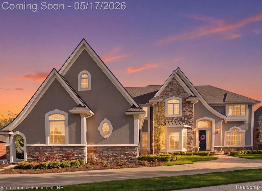 View of front of house with stone siding and stucco siding