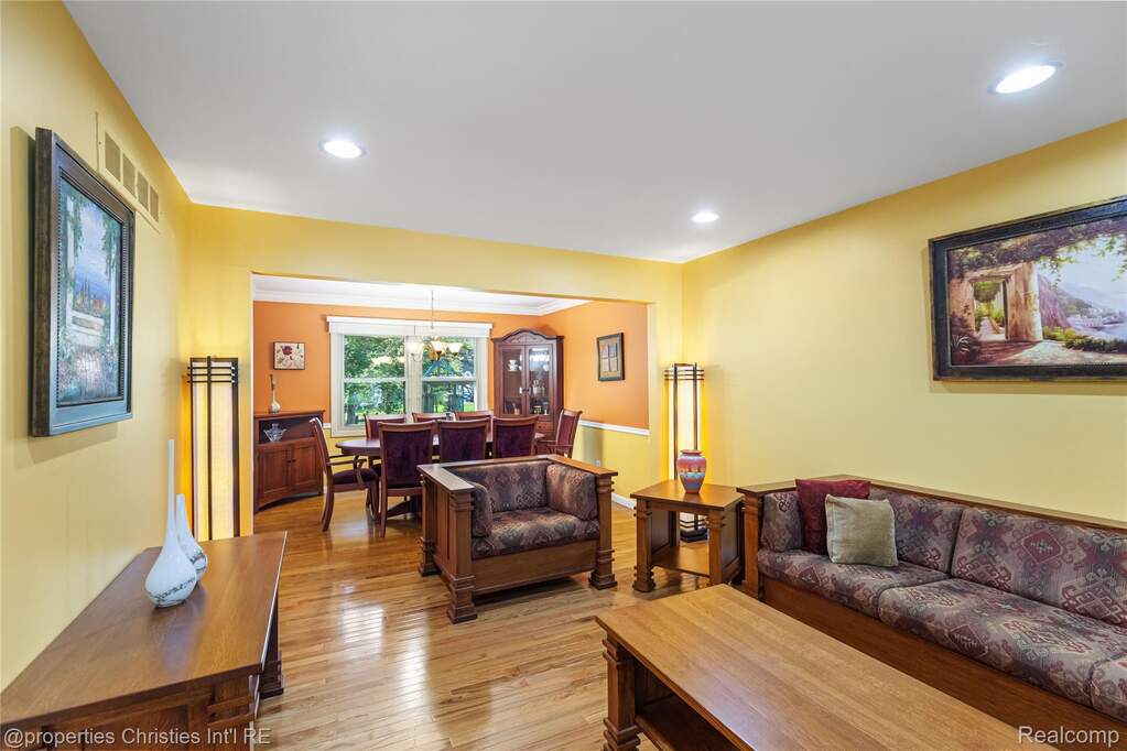 Living area featuring light wood finished floors and suspended lighting