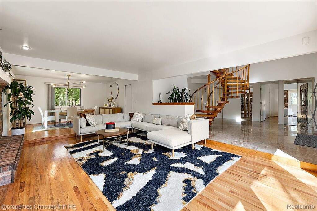 Living room featuring light wood-style floors and a fireplace
