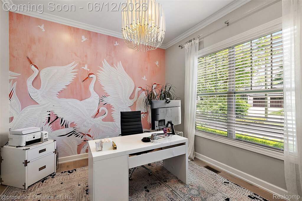 Accent wall with a crane mural, crown molding, a large window with blinds and sheer curtains, wood-finish flooring, and a contemporary chandelier