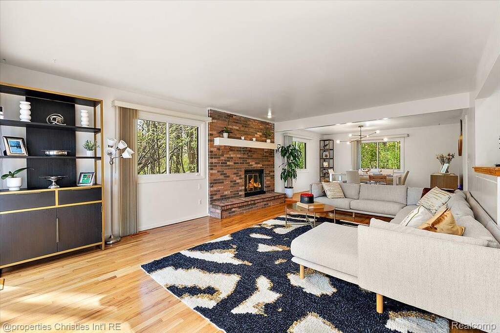 Living room featuring light wood-style floors and a fireplace