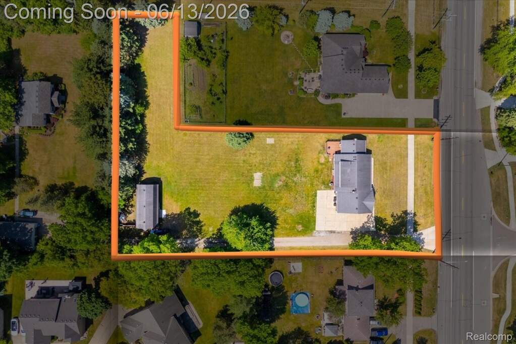 Expansive property featuring a primary residence, a detached auxiliary building, and extensive green space