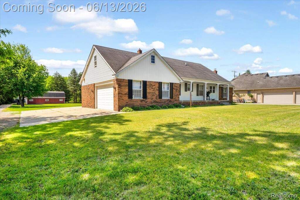 Traditional brick and siding residence with an attached garage