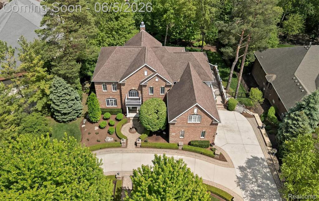 Brick residence featuring a multi-gabled roofline and an elegant front entry