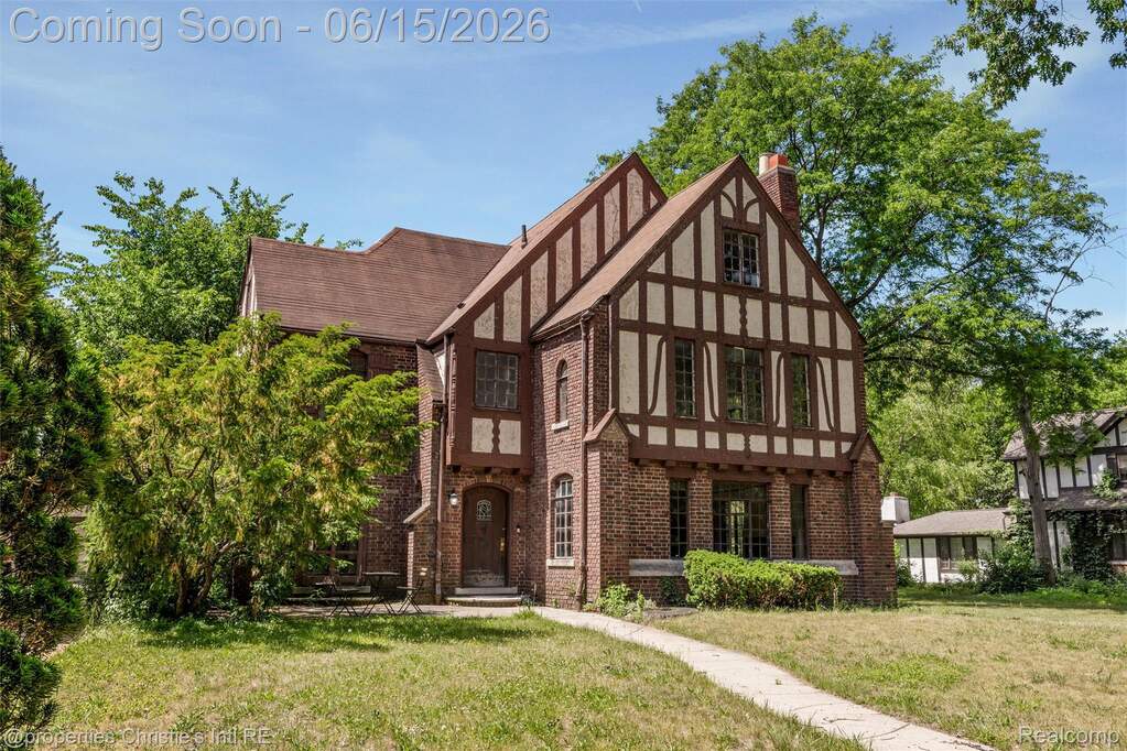 Tudor Revival residence featuring brick and half-timbered facade elements
