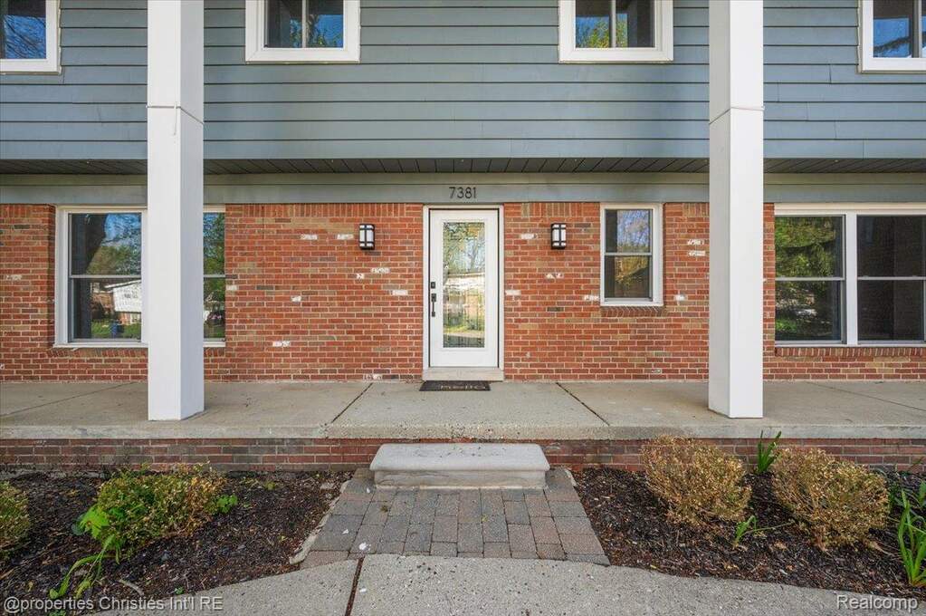 Entrance to property with brick siding
