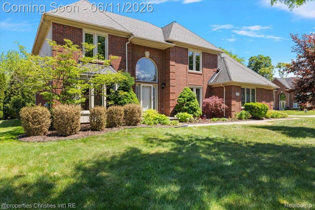 Brick exterior featuring a gabled roofline and arched window