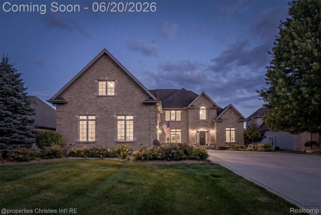 Traditional two-story residence featuring a brick facade and a multi-gabled roofline