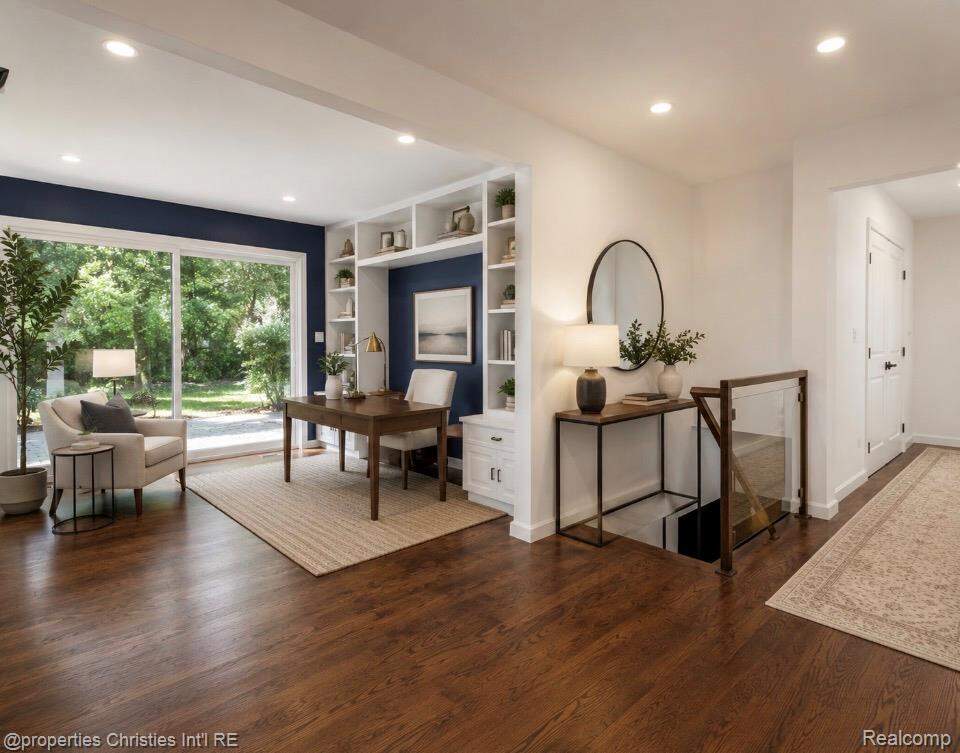 Staged with AI. Entry to home that leads to library/study