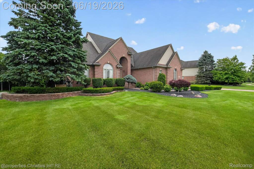 Brick exterior residence with a prominent architectural archway over the entry