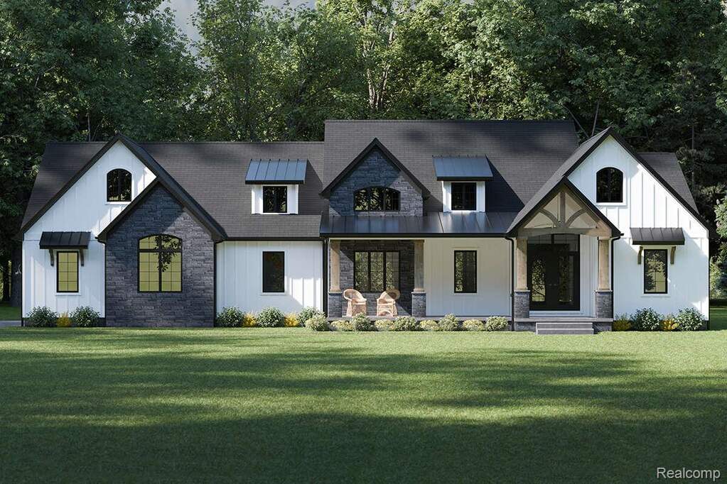 Modern farmhouse exterior featuring white board-and-batten siding with dark stone accents, a dark shingle roof, black-framed windows, and a covered porch with stone and wood columns