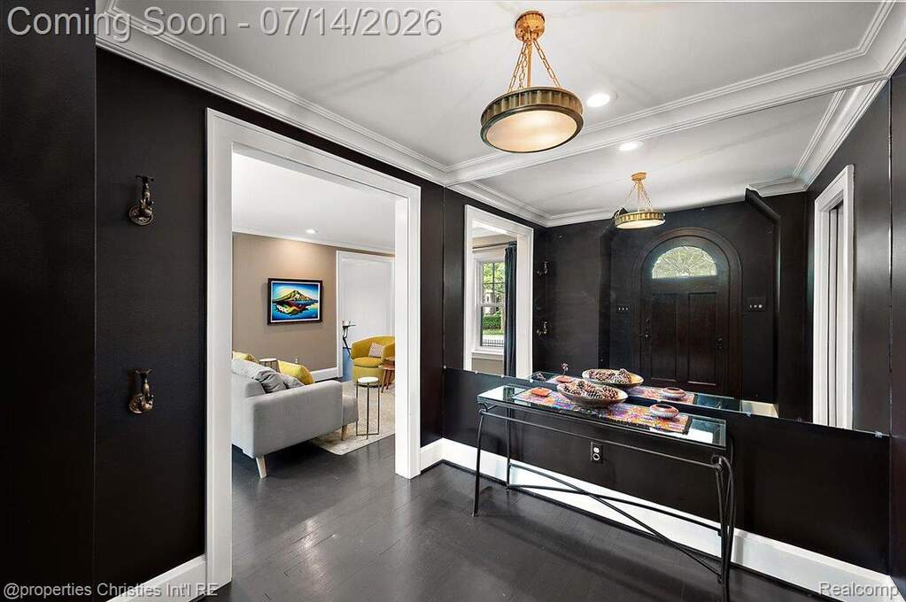 Entryway featuring dark wood-finish flooring and walls