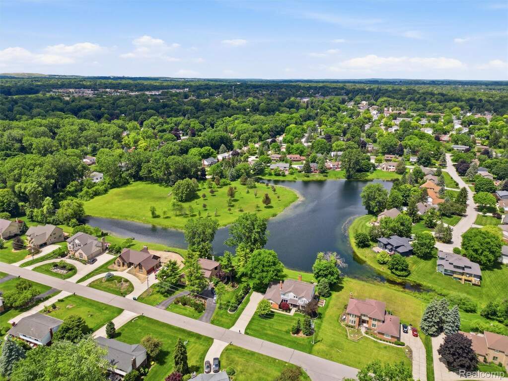 Aerial perspective showcasing a residential area with a prominent body of water