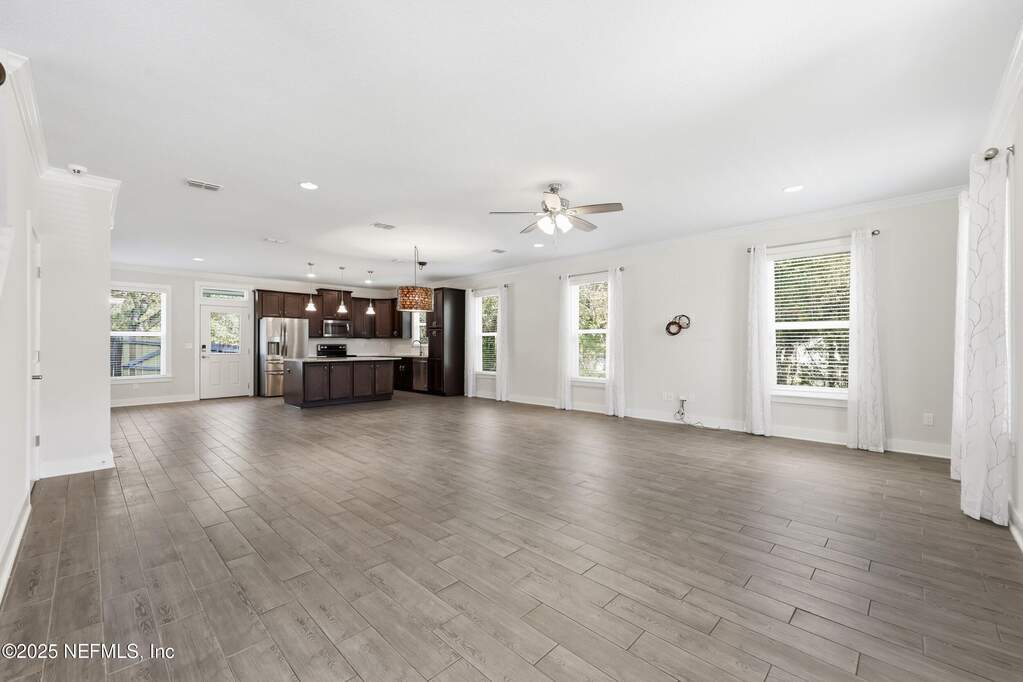 Living and Kitchen Overview – Expansive layout connects the living area to the kitchen, ideal for entertaining or flexible furniture arrangements