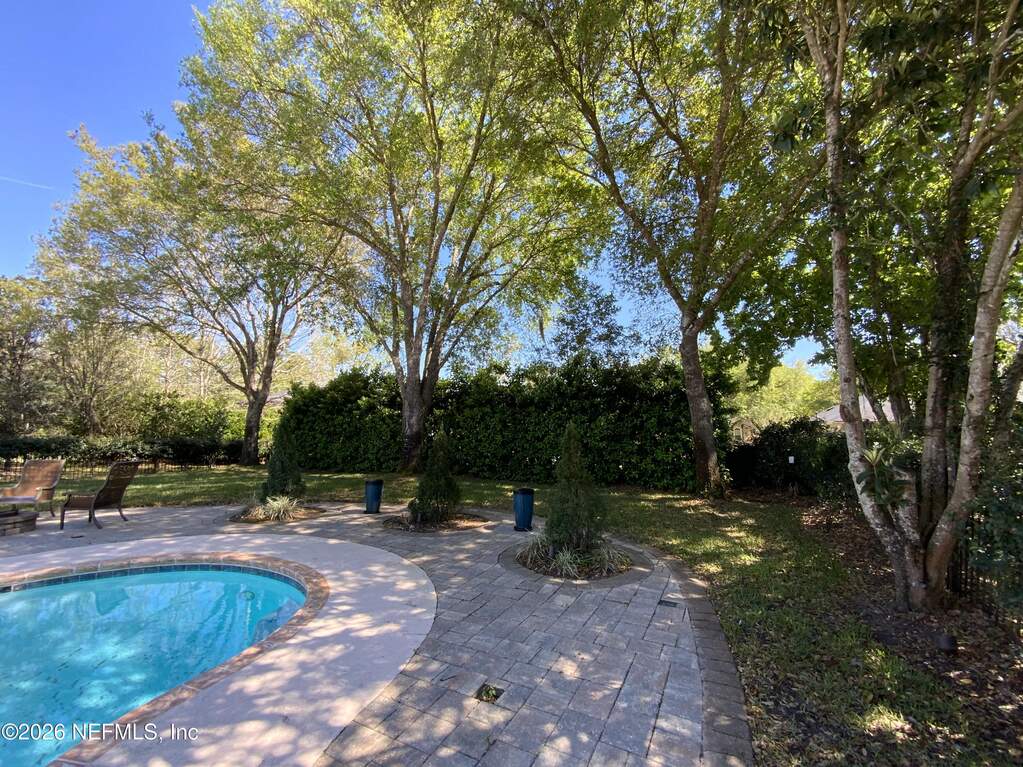Backyard retreat! Florida fun! Notice the trees and shrubs that provide privacy and shade.