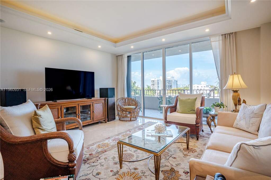 The Living room features floor-to-ceiling glass do