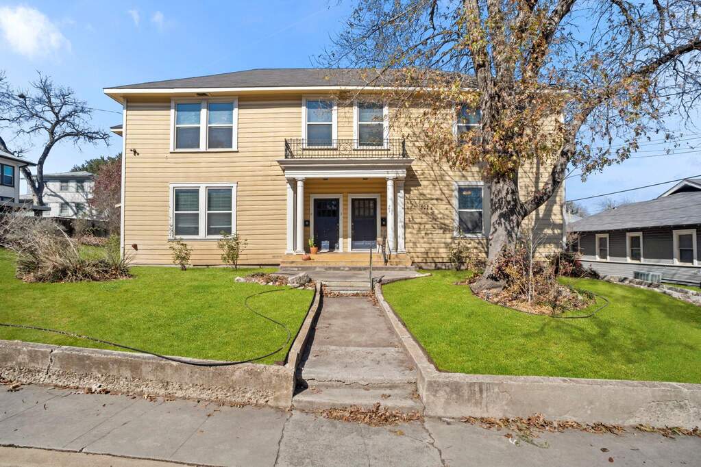 View of front of property featuring a front yard and covered porch