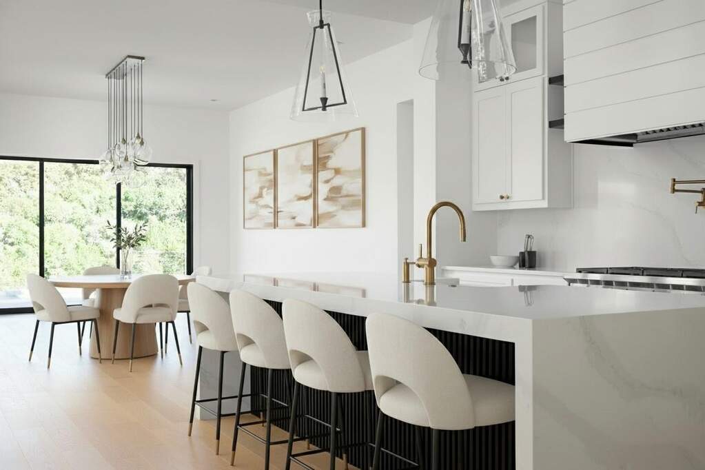 Spacious kitchen featuring a large waterfall-edge island with seating, a brass-finish faucet, and coordinating hardware