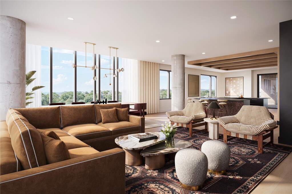 Owner’s lounge featuring south-facing views toward Lady Bird Lake, with comfortable seating, bar area, and large windows that fill the space with natural light. A refined social setting desig