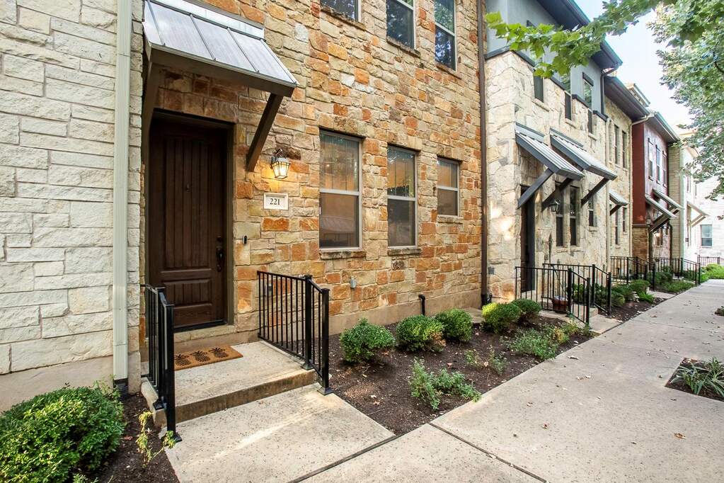 Doorway to property with stone siding
