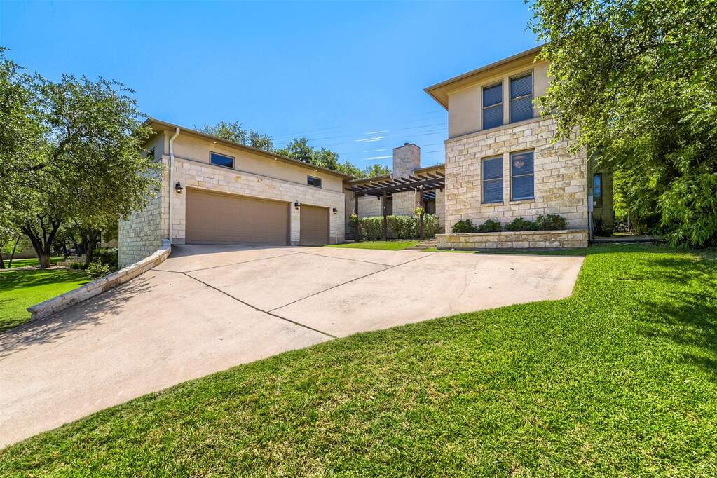 This beautiful two-story exterior sits tucked behind mature trees, offering an immediate sense of privacy right from the street