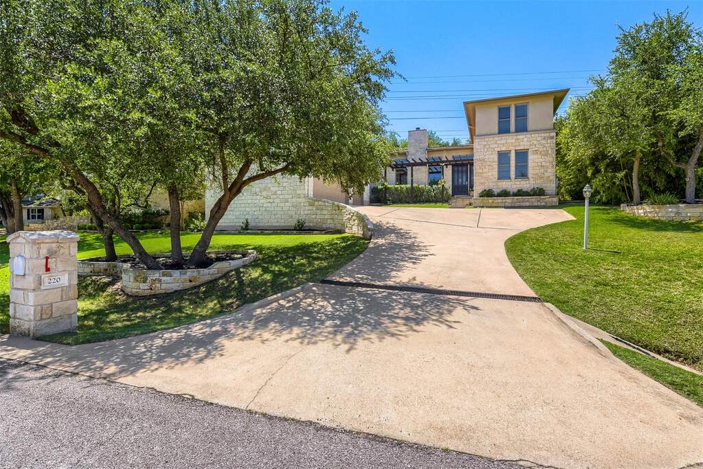 The long driveway provides plenty of off-street parking for guests, leading up to the oversized three-car garage