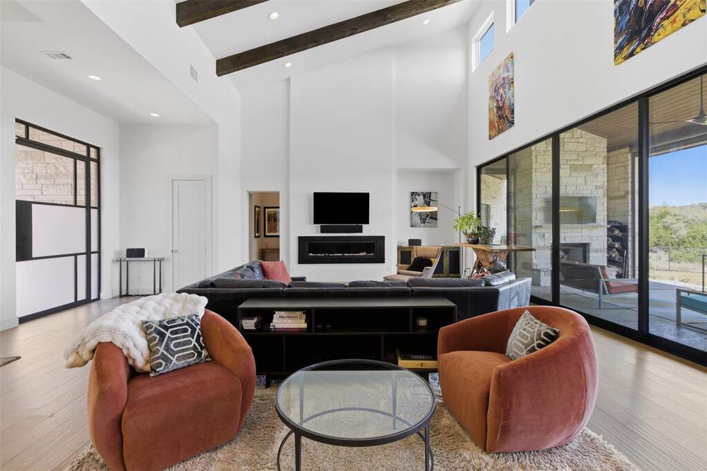 Expansive glass sliders frame uninterrupted Hill Country views, pulling the outdoors in and filling the home with natural light.