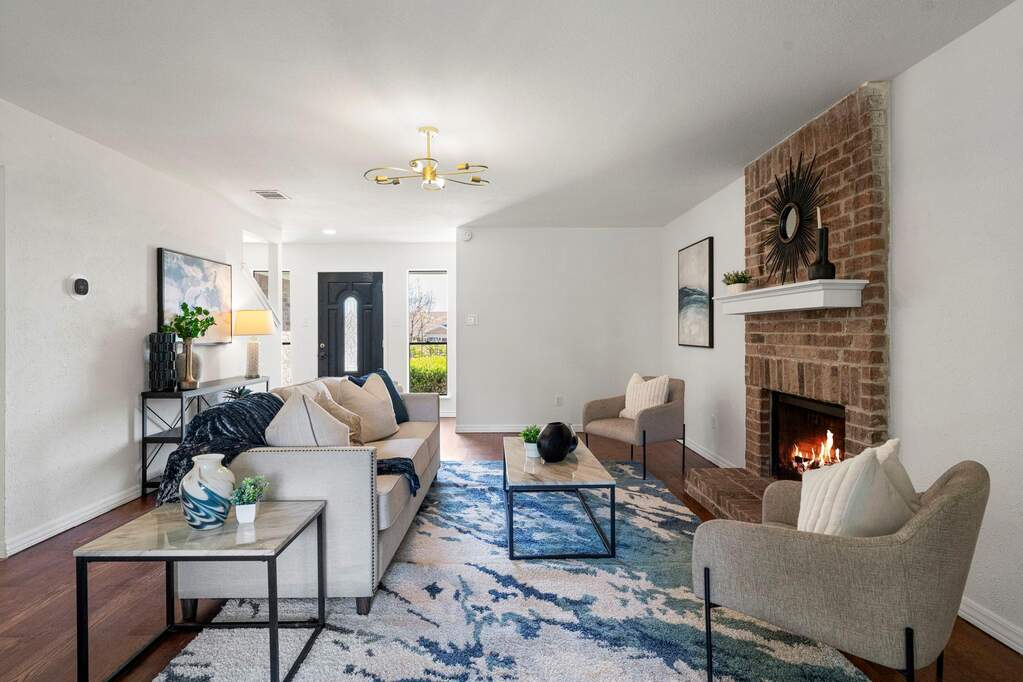 Living area featuring wood finished floors and a brick fireplace