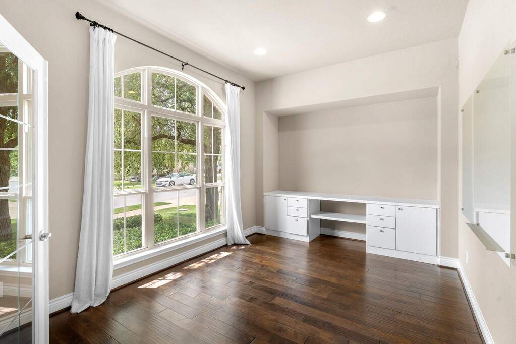 Positioned right off the entryway, the dedicated office features a built-in desk and a large window looking out to the front yard, creating a productive space to focus on remote work