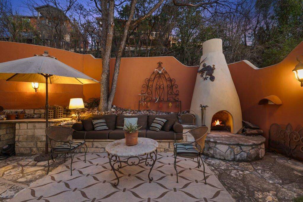Outdoor fireplace, stone patio, and old-school Lake Travis character in full force.