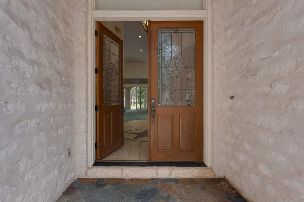 Double front doors with glass inserts create a warm and inviting first impression.