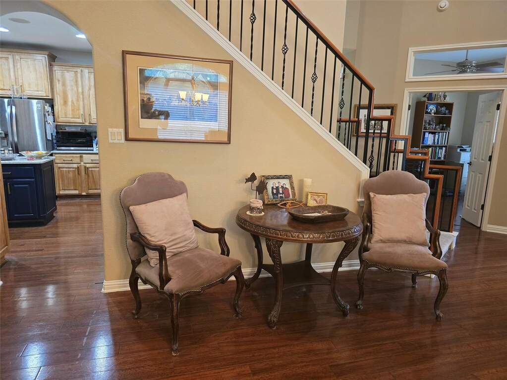 Entry opens into open dining and family room. Office door visible at rear right of image