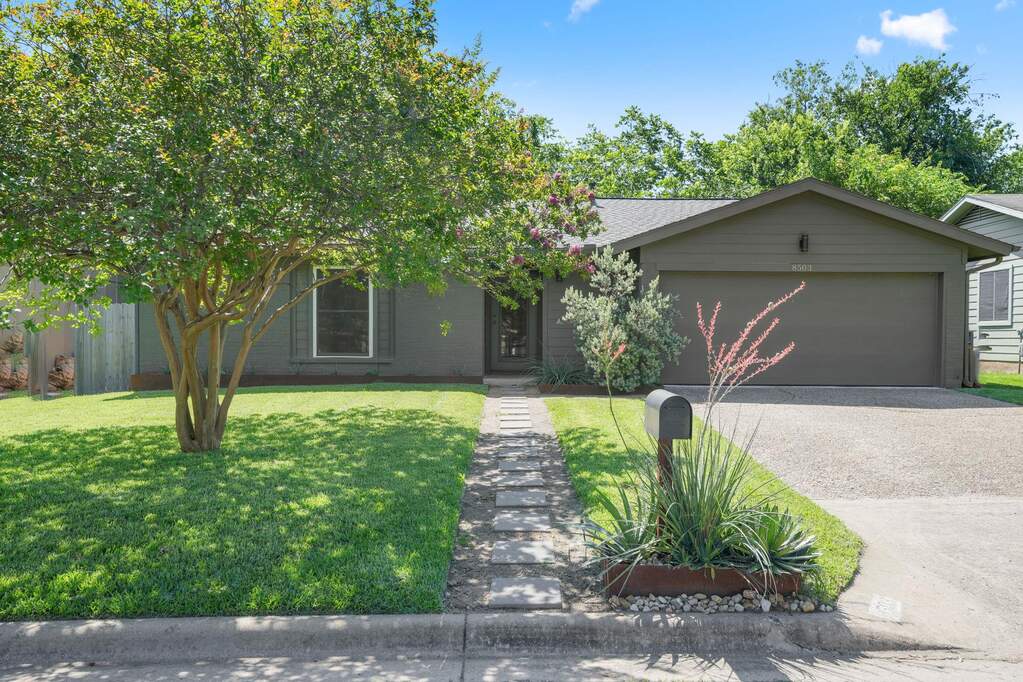 Welcome home to 8503 Cornwall Dr, where the front yard offers great curb appeal with lush grass, a Crepe Myrtle tree, and a dedicated pathway