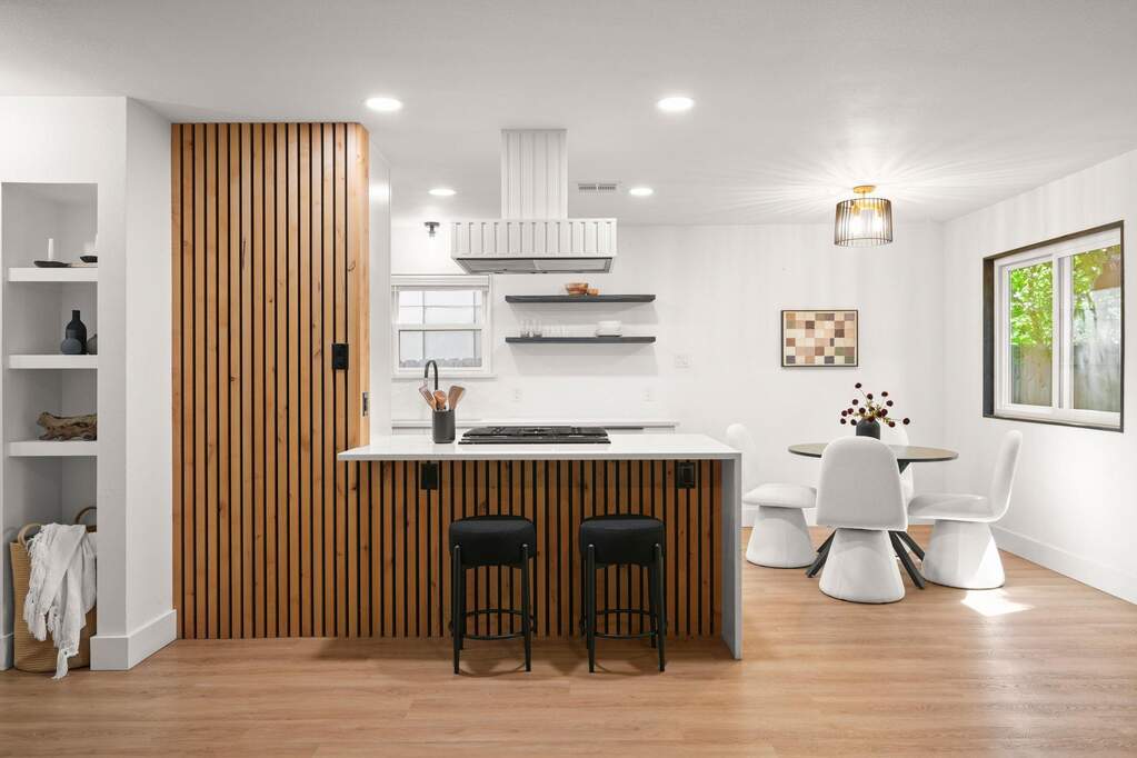 Warm wood tones, modern finishes, and custom shelving make the kitchen a true standout