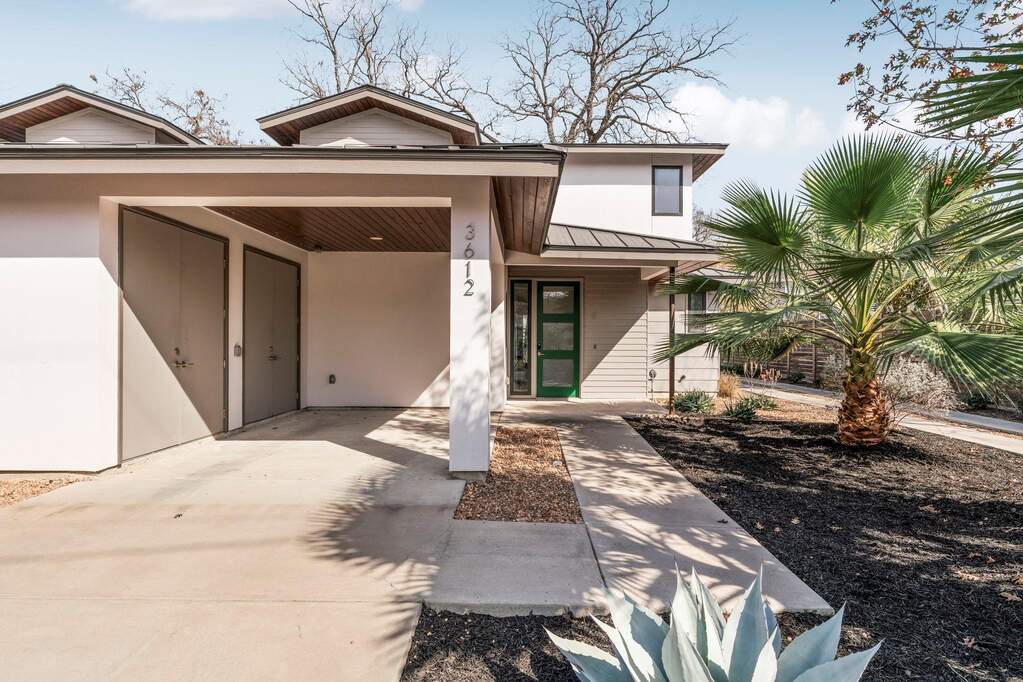 Modern lines, a metal roof, and bold black-framed windows create serious curb appeal from the moment you arrive.