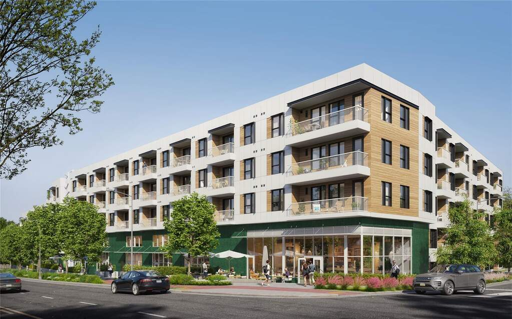 The southwest corner of The Code highlights the building’s design by STG Design, featuring green tile accents, balconies, and ground floor retail dedicated to health, wellness, and dining. A 