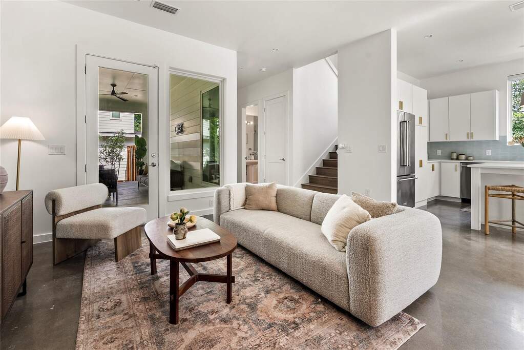 Stepping into the main level, stained concrete floors begin and rich natural light fills the space