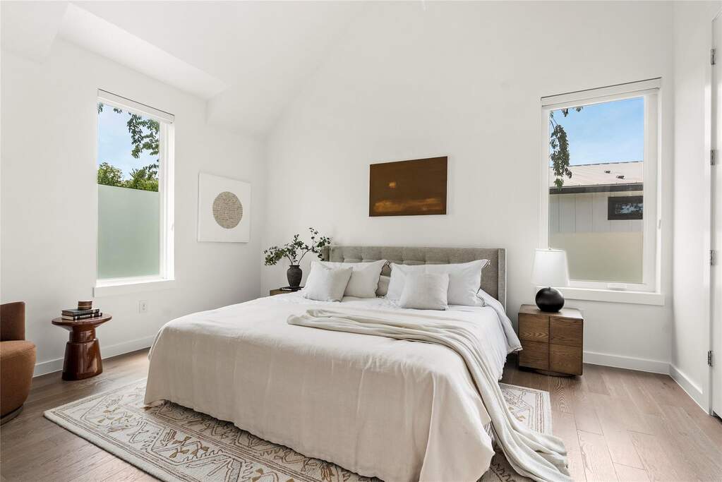The primary suite is an absolute standout, featuring high vaulted ceilings that make the room feel incredibly spacious