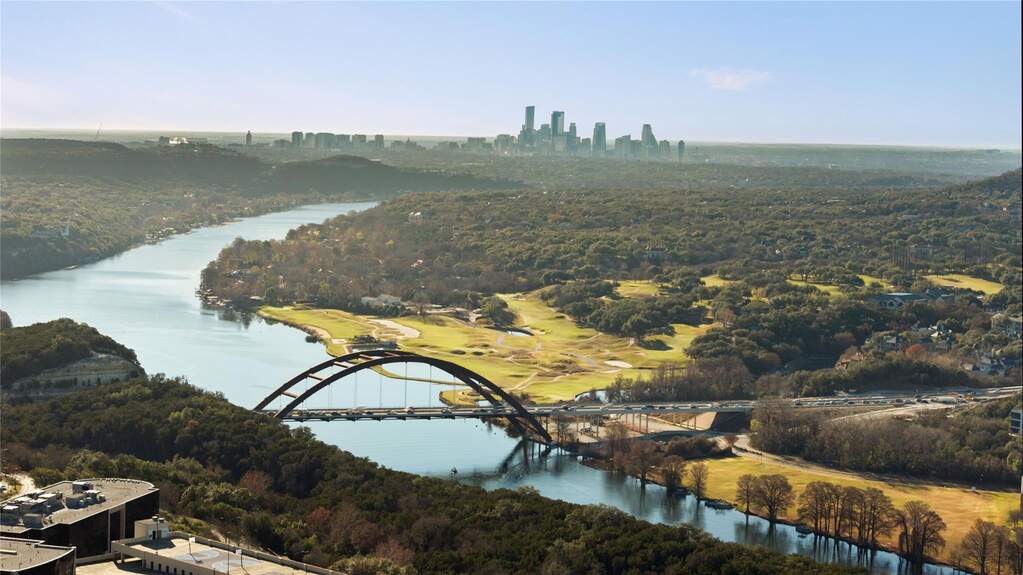 The view over the river toward downtown Austin is especially striking, where water, skyline, and hillside converge into a scene that feels both powerful and composed