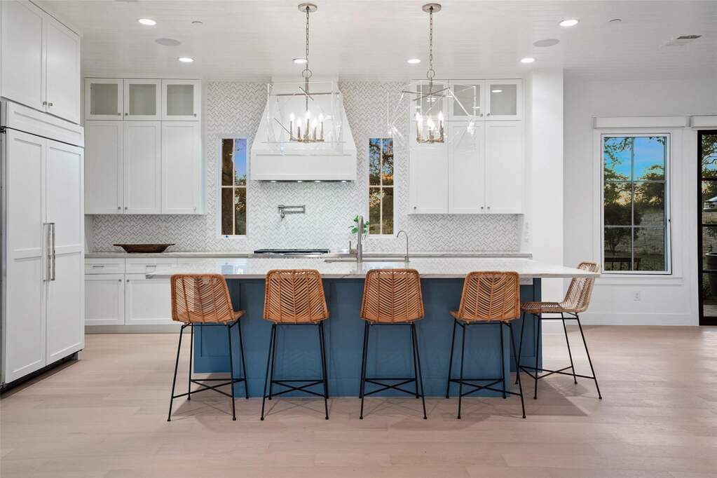 The gourmet kitchen anchors the home with an expansive island ideal for meal prep and morning coffee.