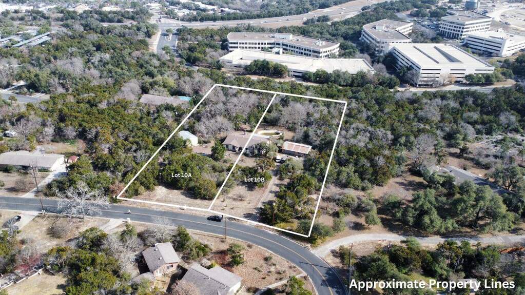Aerial view of property and surrounding area featuring property boundaries highlighted