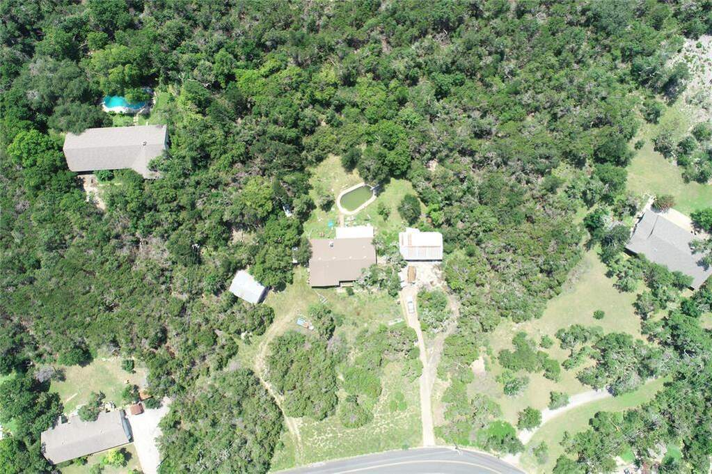 Aerial overview of property's location featuring a heavily wooded area