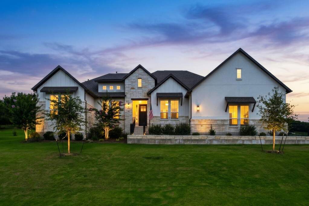 Welcome home to Double Eagle Ranch, where a classic Austin limestone facade and a manicured lawn create a warm, striking first impression the moment you pull into the driveway