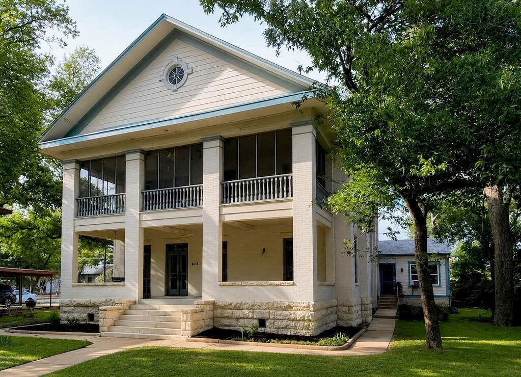 A classic two-story facade with columned screened porches offers ample outdoor living space.