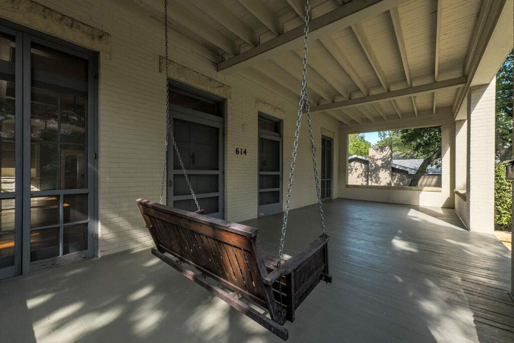 Relax on the covered porch, enjoying gentle breezes and neighborhood views.