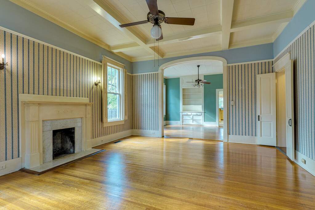 A classic fireplace and hardwood floors define this welcoming living space.