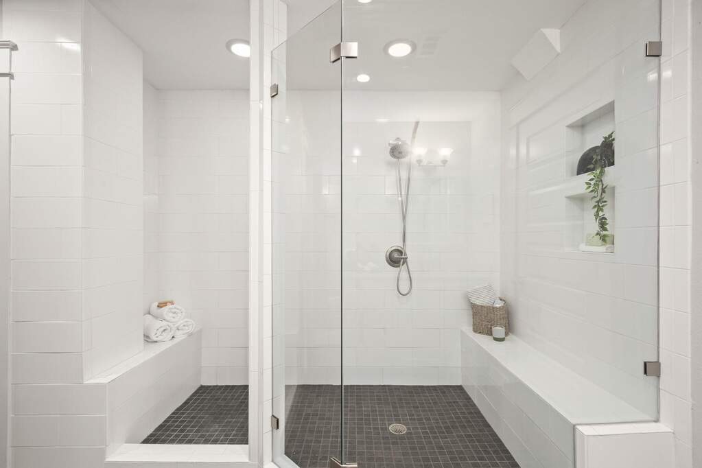 This walk-in shower includes a built-in bench, offering a dedicated spot to slow down and relax during your morning or evening routine